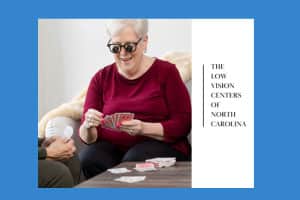 A-smiling,-silver-haired-woman-wearing-bioptic-telescope-glasses-playing-cards-with-a-friend